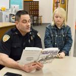 Deputy Marshal Leif Haugen reads to second grader Colby Terry in the library of Coupeville Elementary School. Haugen is part of the recently launched Bigs with Badges program at Big Brother Big Sisters that pairs children in the community with law enforcement officers. Photo by Laura Guido/Whidbey News-Times