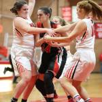 Coupevilles Sarah Wright, left, and Ema Smith put the clamps on Port Townsends Izzy Hammett.(Photo by John Fisken)