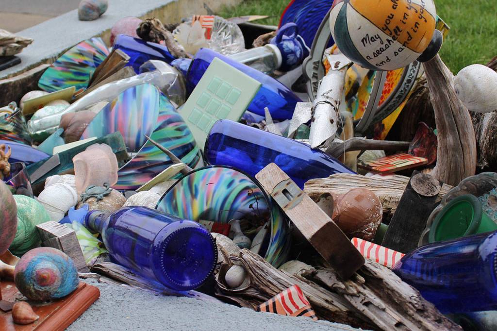 A collection of moon snails, driftwood, colored glass and other flotsam in front of Susan Jensens Cultus Bay home. Photo by Patricia Guthrie/Whidbey News-Times