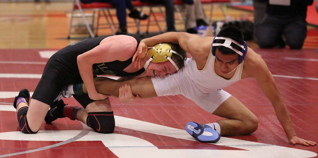 Blake Servatius, left, tries to control Fernie Vasquez of Everett in the match for first place.(Photo by John Fisken)