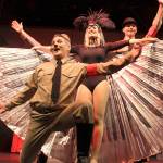 Douglas Langrock as Roger De Bris transforms from a gay director to a gay Hitler in The Producers. Emily Hoyt as Ulla spreads her wings behind him.