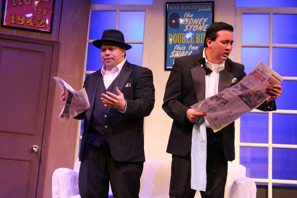 Karl Borja (left) playing Max Bialystick and Fernando Duran as Leo Bloom discover their intended flop is instead a hit with critics.<address><em>                                </em></address>