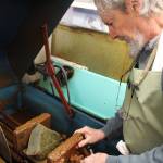 George Gray positions a rock to be sliced at one of many cutting and grinding machines of the Whidbey Island Gem Club, located next to the Oak Harbor Senior Center.
