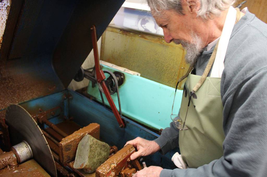 George Gray positions a rock to be sliced at one of many cutting and grinding machines of the Whidbey Island Gem Club, located next to the Oak Harbor Senior Center.