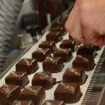 Sea salt is sprinkled on caramels after they go through a waterfall of chocolate. Several Coupeville businesses will be offering a caramel treat this Saturday. Photo by Megan Hansen/Whidbey News-Times.