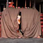 Katie Marti, as a lost boy named Slightly, peeks out of the lost boys camp during rehearsal Monday evening. Coupeville Elementary Schools drama club will present Peter Pan at noon on Saturday at the Coupeville Middle School Performing Arts Center. Photo by Laura Guido/Whidbey News-Times