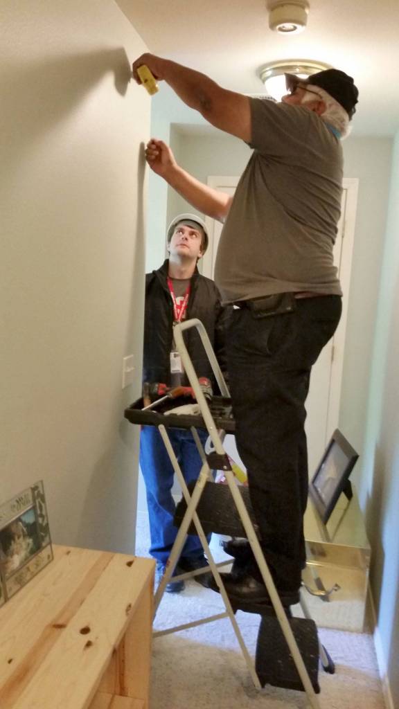 Making sure home owners have working smoke detectors is another part of Hearts & Hammers. Through the American Red Cross, volunteers install the free smoke detectors and discuss fire exit strategy with residents. Photo provided
