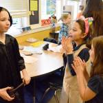 Allison Garcia (front right) and Angelina Heroff applaud after Emilie Perrins presentation on Sonia Sotomayor on Wednesday. Perrin was one of around 70 fourth graders who either dressed up as their chosen notable person or created a poster. Photo by Laura Guido/Whidbey News-Times