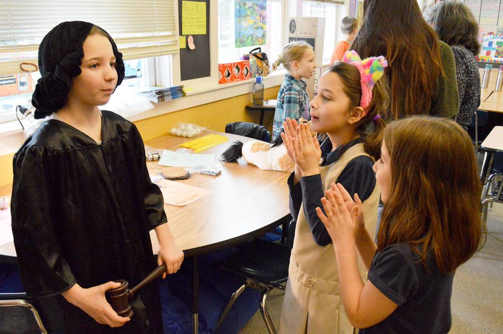 Allison Garcia (front right) and Angelina Heroff applaud after Emilie Perrins presentation on Sonia Sotomayor on Wednesday. Perrin was one of around 70 fourth graders who either dressed up as their chosen notable person or created a poster. Photo by Laura Guido/Whidbey News-Times