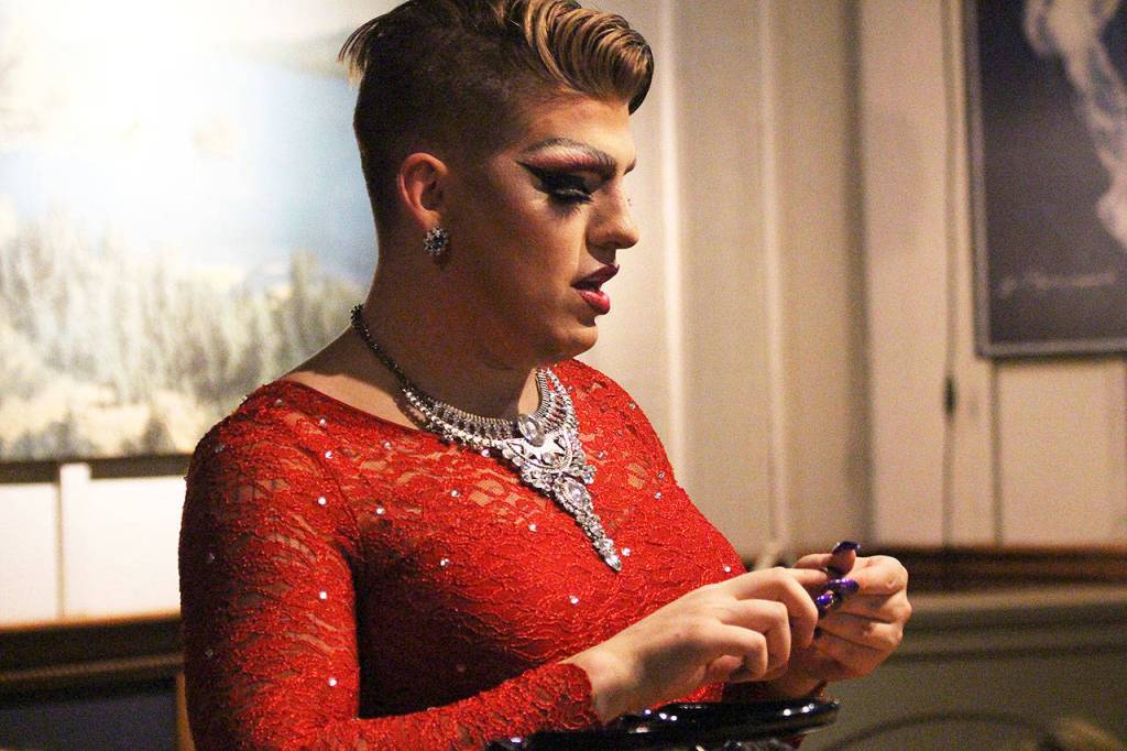 Vivienne Duchanne works on getting her nails just right before deciding on which wig to don. In one act, she switches wigs six times. Photo by Laura Guido/Whidbey News-Times