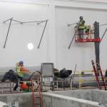 Photo by Jessie Stensland / Whidbey News-Times                                Members of a construction company work inside one of the buildings that makes up the sewage treatment plant being built in Oak Harbor