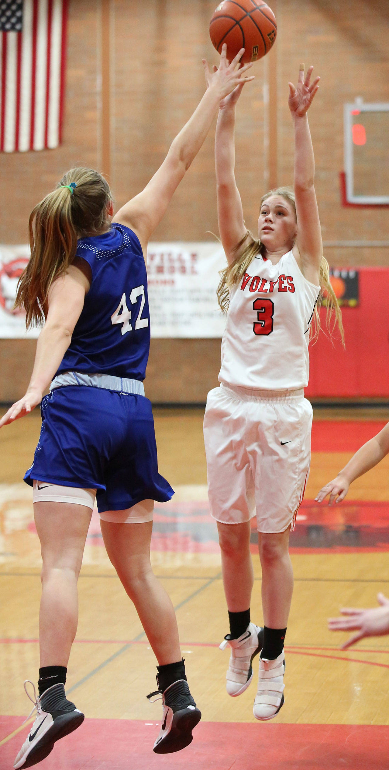 Chelsea Prescott fires a shot over the defense of Bellevue Christians Molly Olson. (Photo by John Fisken)