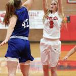 Chelsea Prescott fires a shot over the defense of Bellevue Christians Molly Olson. (Photo by John Fisken)