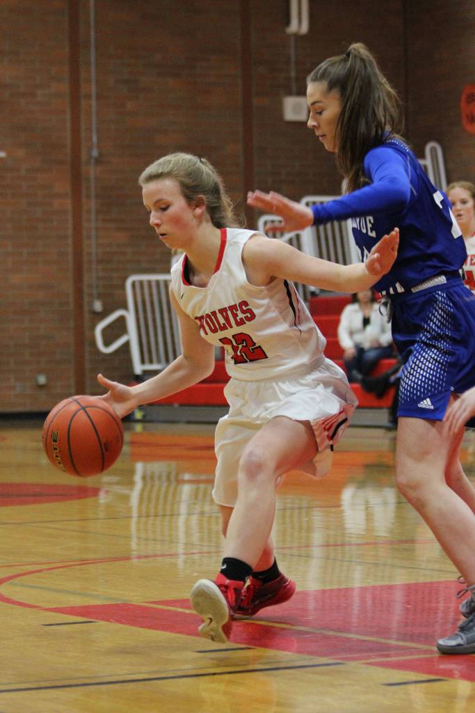 Allison Wenzel, left, fends off the defense of the Vikings Molly VandenBrink.(Photo by Jim Waller/Whidbey News-Times)