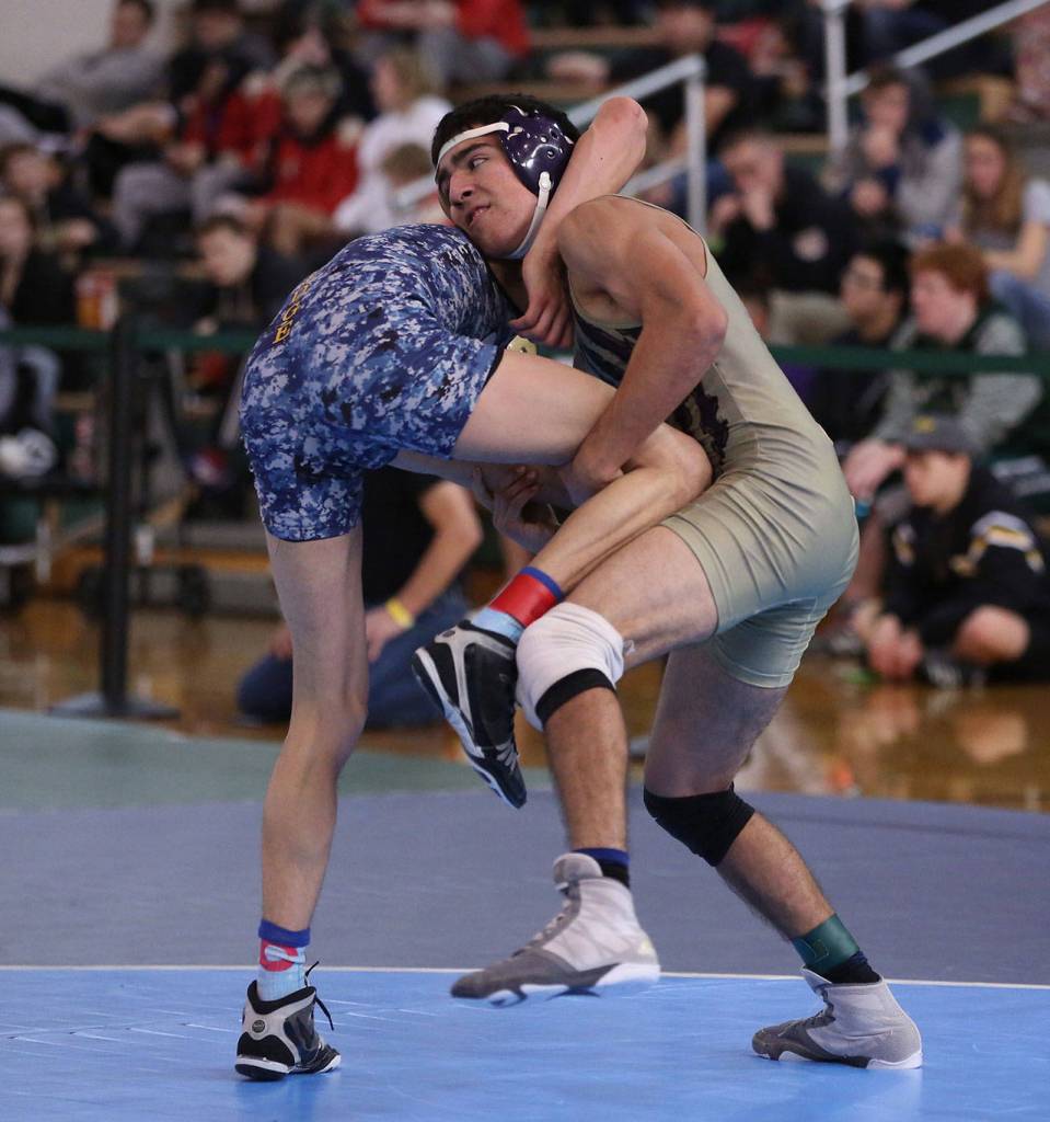 Caleb Fitzgerald tries to take down Southridges Giovanni Penaloza in the match for third place. Penaloza went on to win 9-1.(Photo by John Fisken)