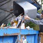 Keith Woodman dumps his mixed paper into the bin at the recycle center in Coupeville. Washington state faces a problem of having too much contaminated material, which is something Rep. Norma Smith, R-Clinton, aims to address in her recent bill. Photo by Laura Guido/Whidbey News-Times