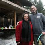 Evan Thompson / The Record  Marc Swenson (right) holds the hose that he used to help put out a fire that had started in Erin Kellys chicken coop this past week. His quick action prevented the fire from spreading to the rest of the house.