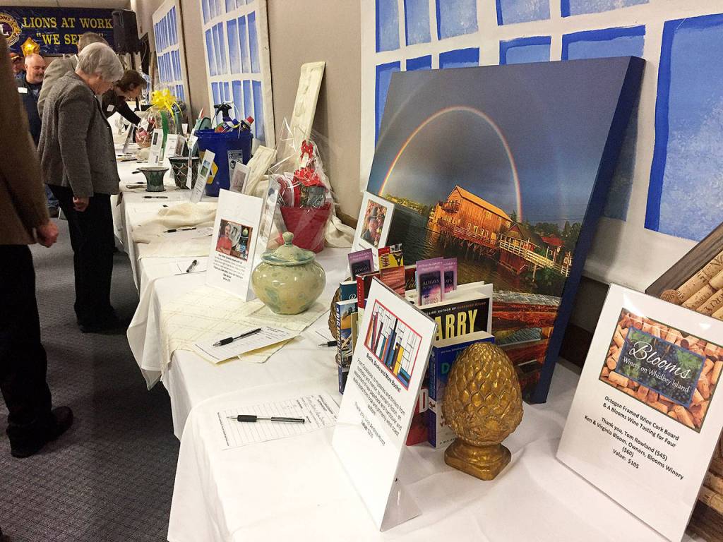 Photo above: The evening started with a cocktail hour and silent auction. Among items up for bid were local artwork, gift baskets and experiences.