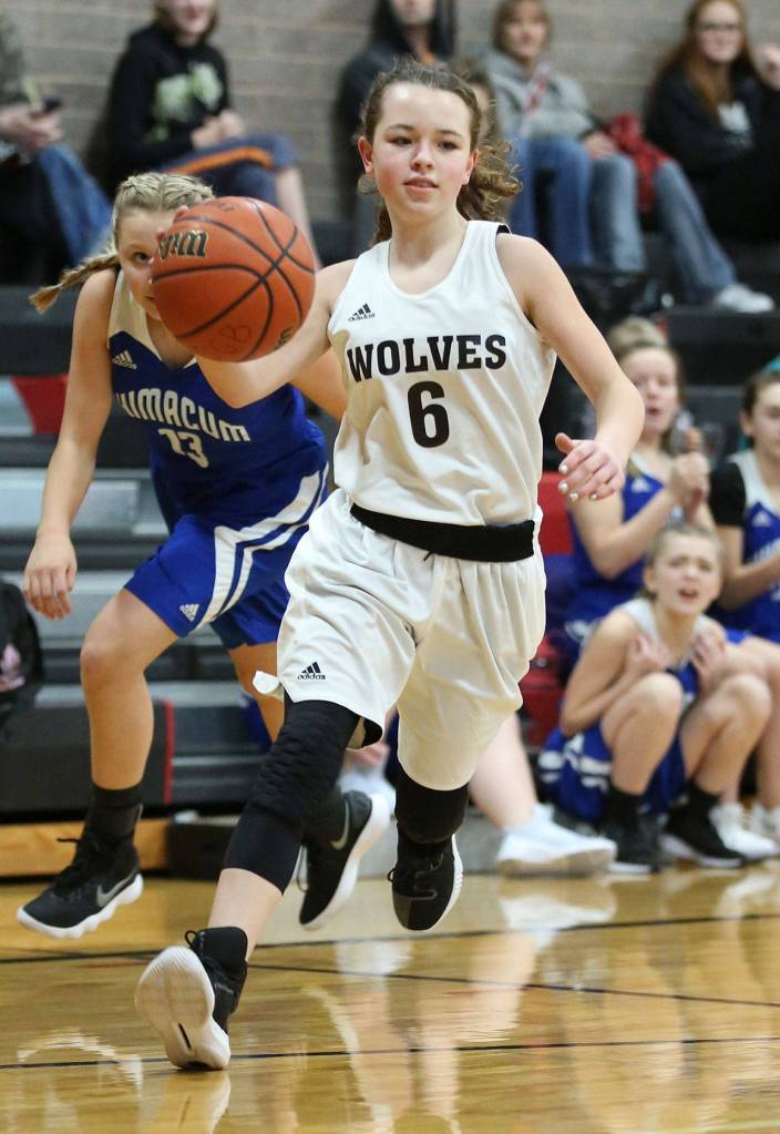 Gwen Gustafson hustles the ball up the floor for the seventh-graders.(Photo by John Fisken)
