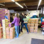 Photo by Anni Powell/Whidbey News-Times                                Jennifer Wilkins, at right, a Girl Scout leader and creative manager for Whidbey News Group, carries boxes of cookies during the local groups distribution day. The Scouts utilized the Oak Harbor garage that was once home to the Whidbey News-Times printing press.