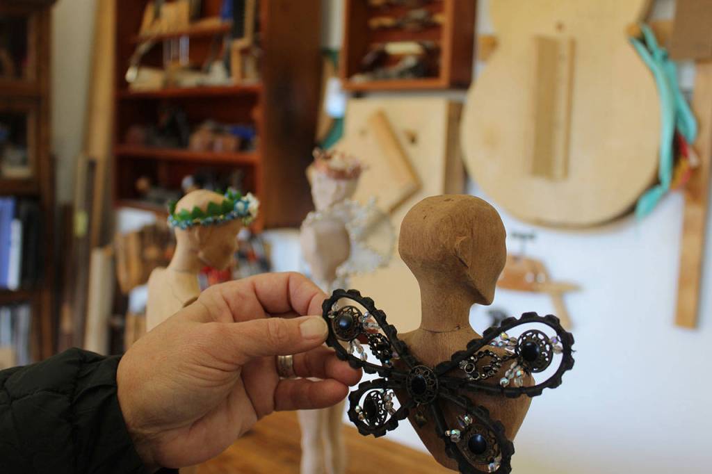 Janet Lewis found many uses for discarded objects, such as this old machine belt adorned with old jewelry to form butterfly wings.
