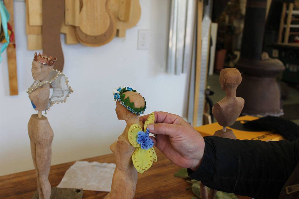 Janet Lewis, who usually makes high-end wooden instruments, has been having fun finding ways to decorate three wooden figures she carved. Its been a real freeing process, Lewis said.