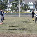 Members of the Oak Harbor High School softball team warm up for practice Thursday. (Photo by John Fisken)