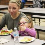 Photo by Laura Guido/Whidbey News-Times                                Reagan Olson, 3, chows down on her spaghetti Thursday night with her mother Shannon Olson at Oak Harbor Elementary.