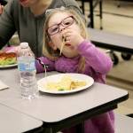 Photo by Laura Guido/Whidbey News-Times                                Reagan Olson, 3, chows down on her spaghetti Thursday night at Oak Harbor Elementary. Her family received a free dinner through the READY! for Kindergarten program, which aims to promote literacy, math and social skills in kids ages 0-5.