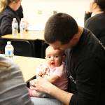 Edward Wilson bounces his daughter Emma Wilson on his lap during a READY! for Kindergarten workshop at Oak Harbor Elementary. The free school district classes teach parents how to prepare their kids for kindergarten and the district provides a free meal and daycare. Photo by Laura Guido/Whidbey News-Times