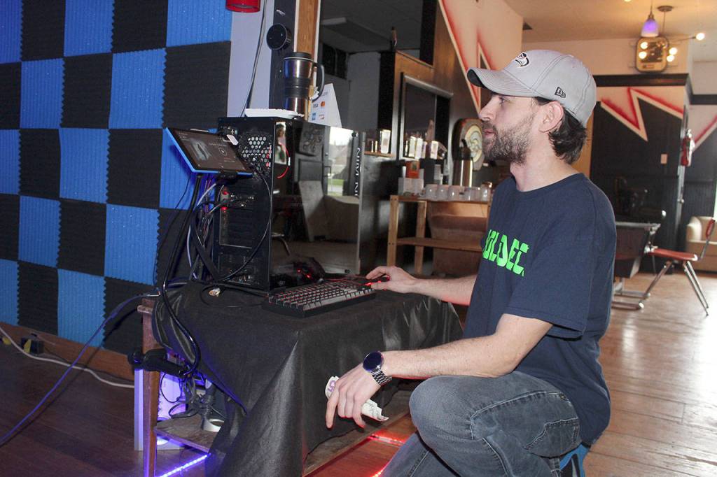 Commercial fees charged to lease virtual reality programs are one of the biggest expenses of his new business, Ethan Worthington says. He controls all the weird worlds that his customers experience from this computer.