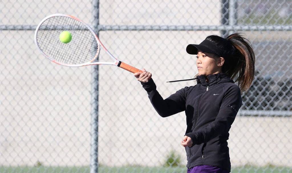 Katrina Martinez smacks a forehand in second doubles Thursday.(Photo by John Fisken)