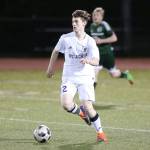 Brandon McCracken looks to pass for Oak Harbor in the Mount Vernon match.(Photo by John Fisken)