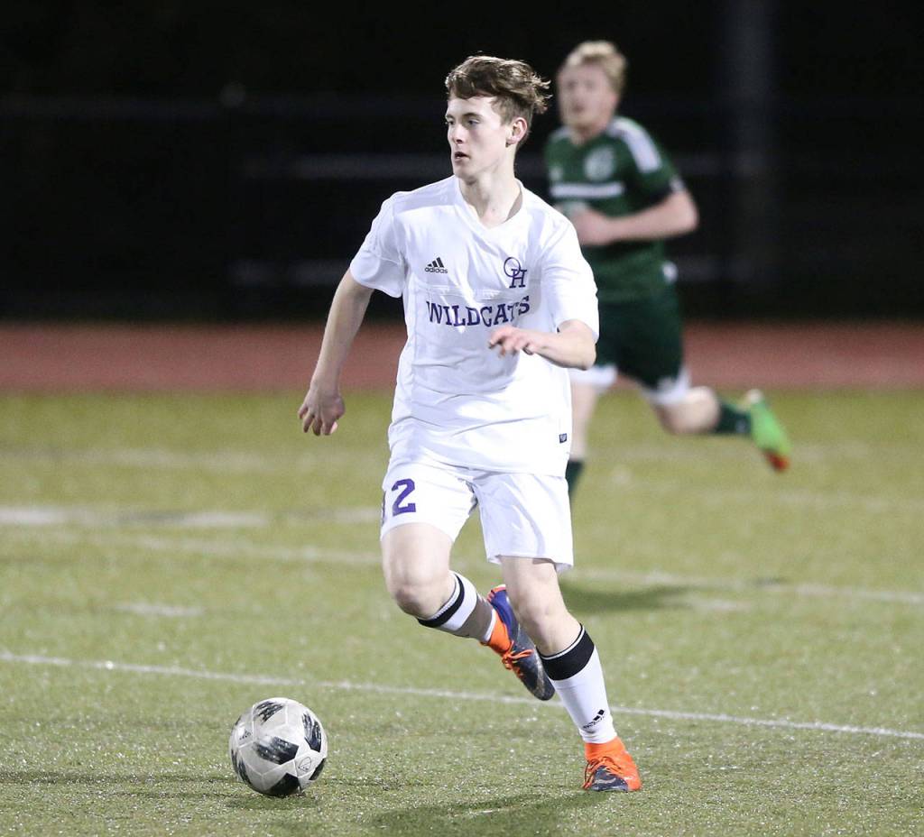 Brandon McCracken looks to pass for Oak Harbor in the Mount Vernon match.(Photo by John Fisken)