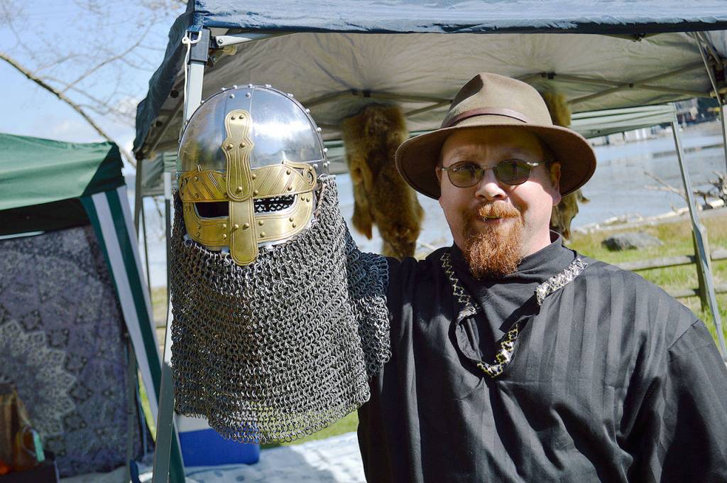 Dave Arnold, of Oak Harbor, holds up his costum helmet used in reenactment battles. There are a number of rules around armor used in combat to ensure the safety of the fighters. Photo by Laura Guido/Whidbey News Group