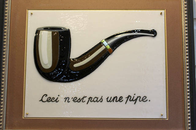 In some of her work, Gina Michel takes famous art images and captures them in fused glass. This one is Magrittes This is not a Pipe.