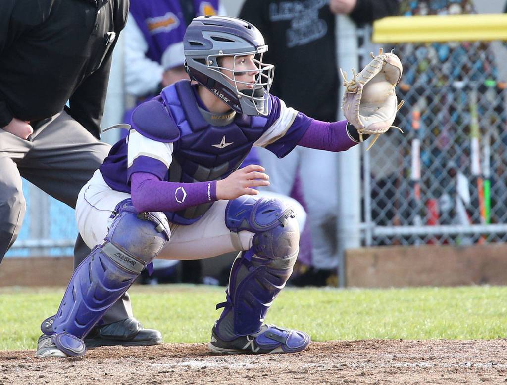 Oak Harbor catch Aiden McCarthy looks in a pitch Friday. McCarthy was the Wildcats offensive star with a home run.(Photo by John Fisken)