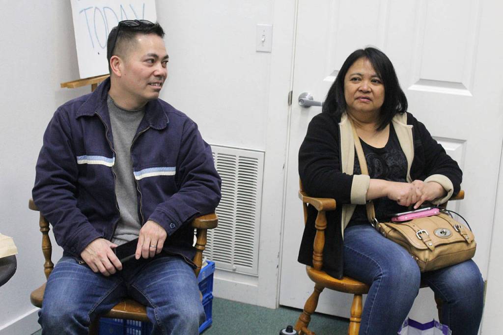 Parents Phat Tang and Arllien Guerrero watch their respective sons practice their Korean martial arts routine Saturday at a coaching session. The boys met learning taekwondo and came up with their routine, Five Finger Death Punch, together.