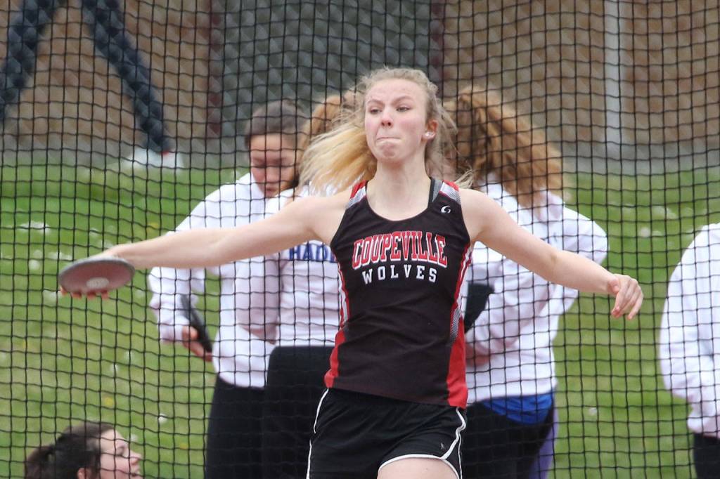 Allison Wenzel flips the discus in Coupevilles track meet Wednesday. (Photo by John Fisken)