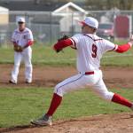 Dane Lucero tosses a pitch in Fridays game with Port Townsend. Lucero teamed with Matt Hiborn, playing third base in the background before taking over on the mound, for a one-hitter.(Photo by John Fisken)