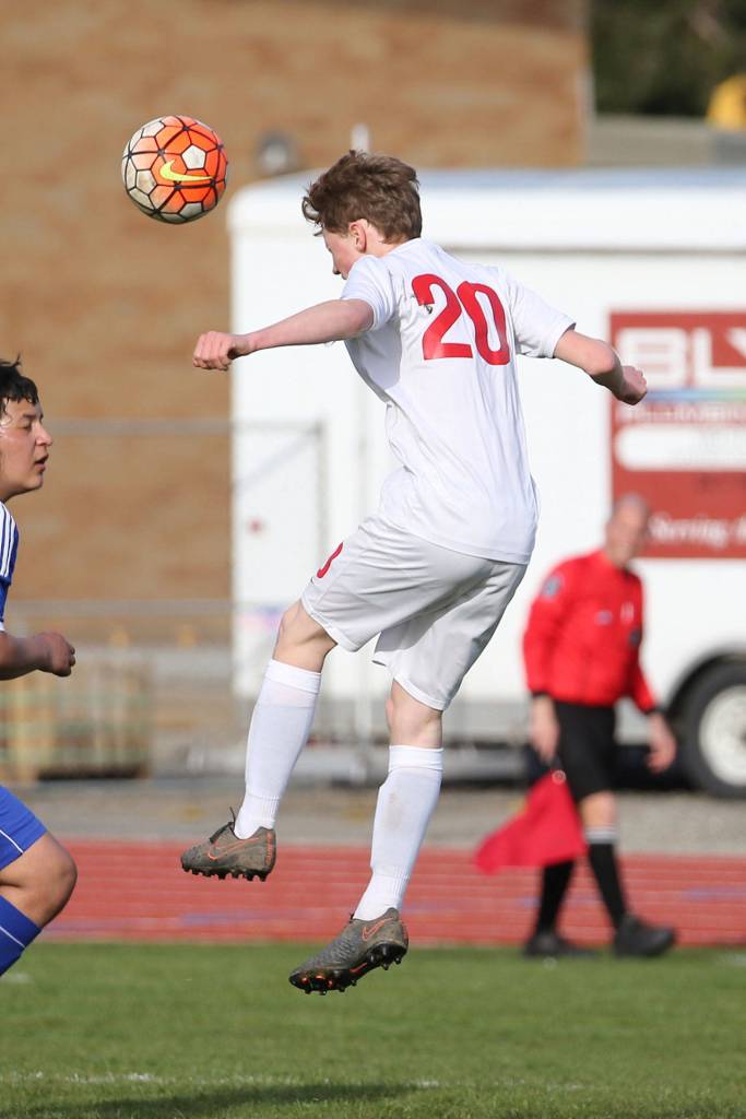 Sam Wynn pushes the ball forward for the Wolves. Wynn scored three goals in the win over Chimacum.(Photo by John Fisken)