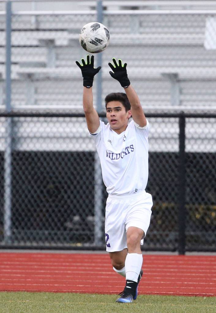Kanoa King puts the ball in play for the Wildcats.(Photo by John Fisken)