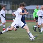 Oak Harbors Ethan Snell boots the ball in the Wildcats match with Arlington Monday.(Photo by John Fisken)