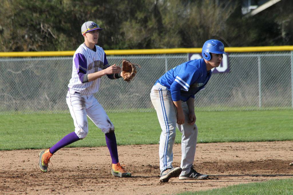 Oak Harbor shortstop Joe Dixon, left, keeps a Shorewood runner close at second.(Photo by Jim Waller/Whidbey News-Times)