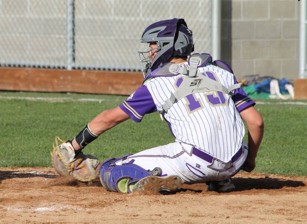 Oak Harbor catcher Aiden McCarthy scoops up an outside pitch.(Photo by Jim Waller/Whidbey News-Times)