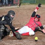 Coupevilles Veronica Crownover slides safely into home before Meridian catcher Audrey Mark receives the throw. (Photo by John Fisken)