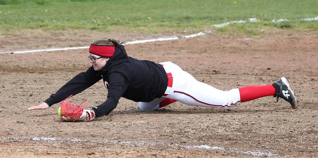Shortstop Katrina McGranahan dives to catch a Forks pop-up.(Photo by John Fisken)