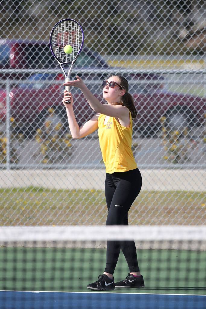 Danielle Lonborg serves in her first doubles match.(Photo by John Fisken)