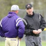 Oak Harbor coach Cody Anderson discusses a play with one of the umpires Wednesday. Several questionable calls hurt the Wildcats.(Photo by John Fisken)