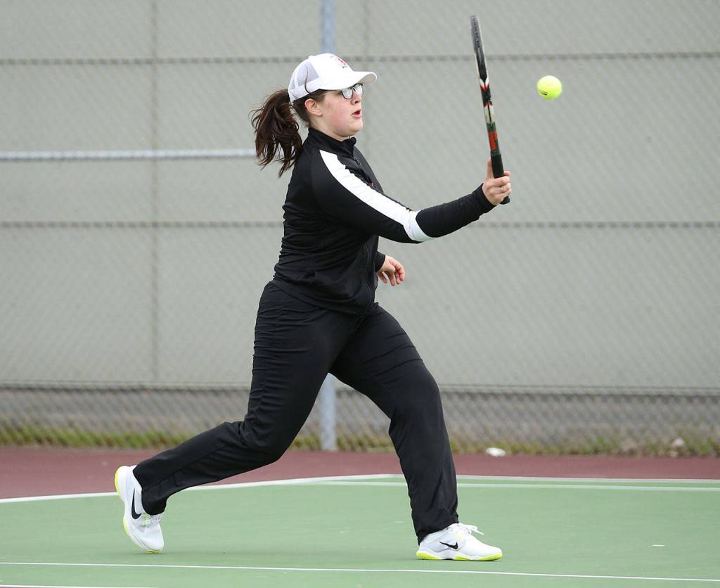 Claire Mietus attacks the ball in first singles Friday.(Photo by John Fisken)
